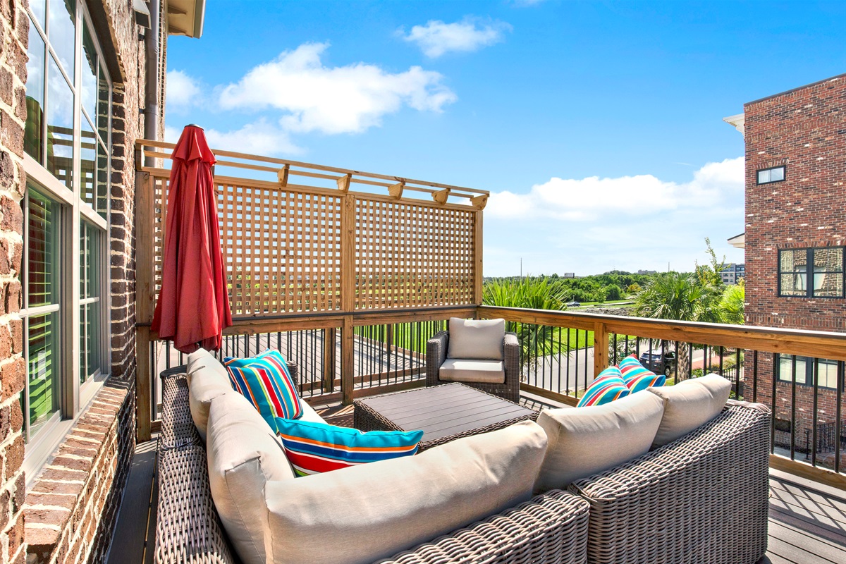 2nd floor Outdoor patio with chair and sectional seatingoff of the living room