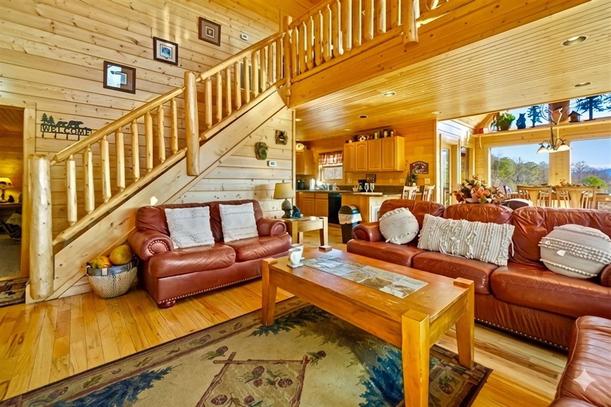 Step into this spacious living room where mornings begin with soft sunlight streaming through the windows and evenings end with laughter by the fire. It’s the heart of the cabin a place to gather, relax, and make memories that linger long after your stay.