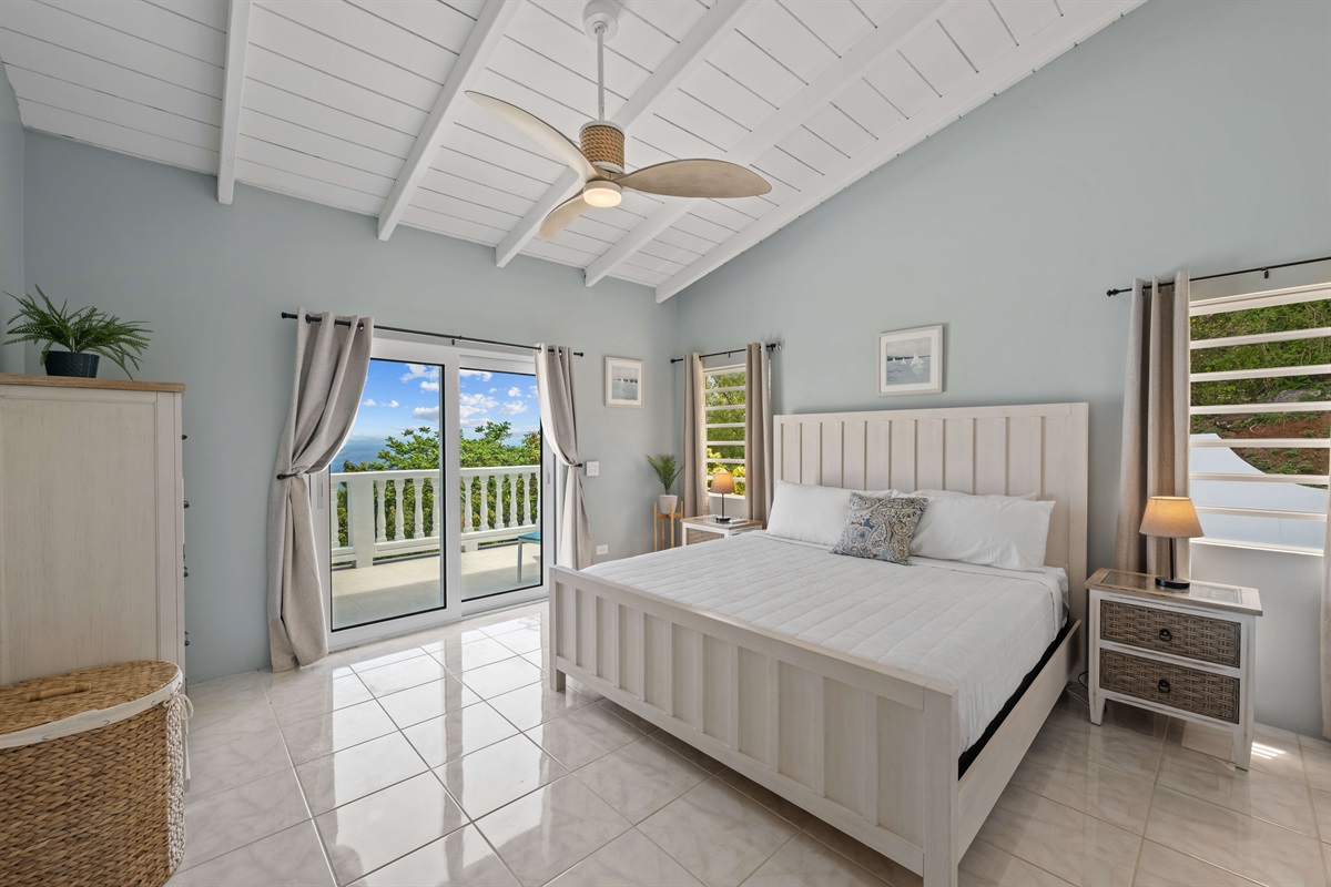 Primary bedroom with a king bed, air conditioning, and ceiling fan