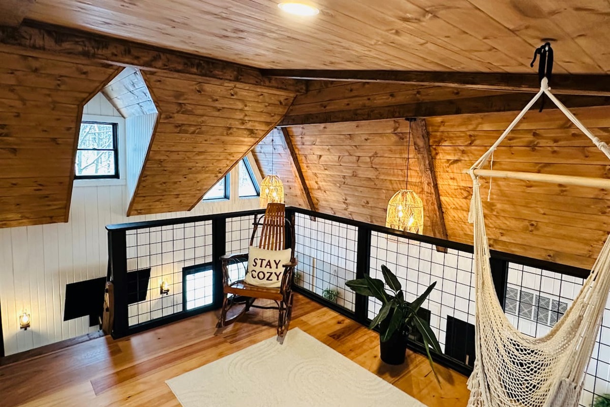 This cozy, open loft features a comfortable queen pullout sofa bed, perfect for two people. The loft overlooks the living room, offering a unique blend of privacy and openness, ideal for those who enjoy a spacious and airy living environment.
