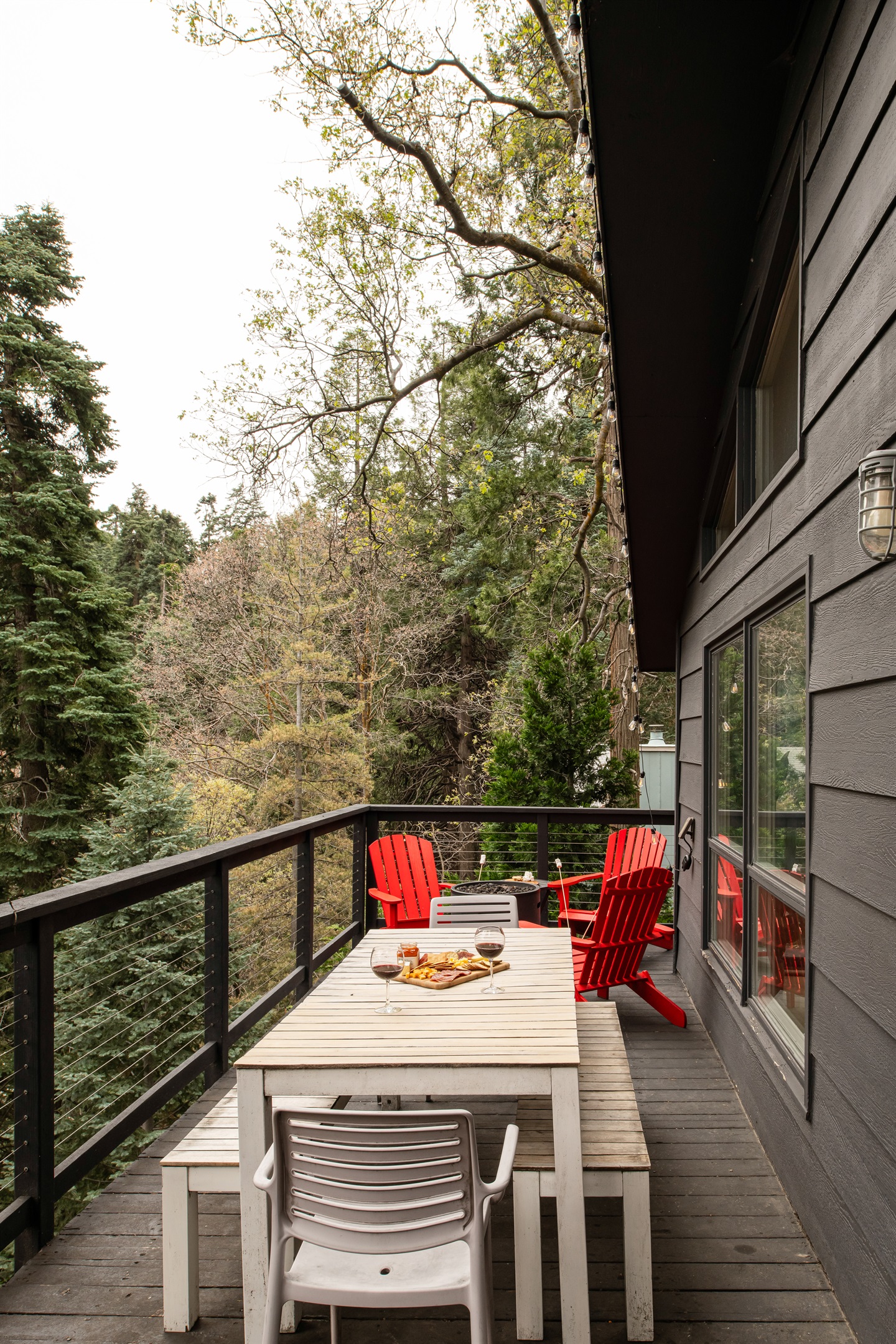 Private deck with outdoor dining and forest views—perfect for morning coffee, al fresco meals, and relaxing in your Lake Arrowhead mountain retreat.