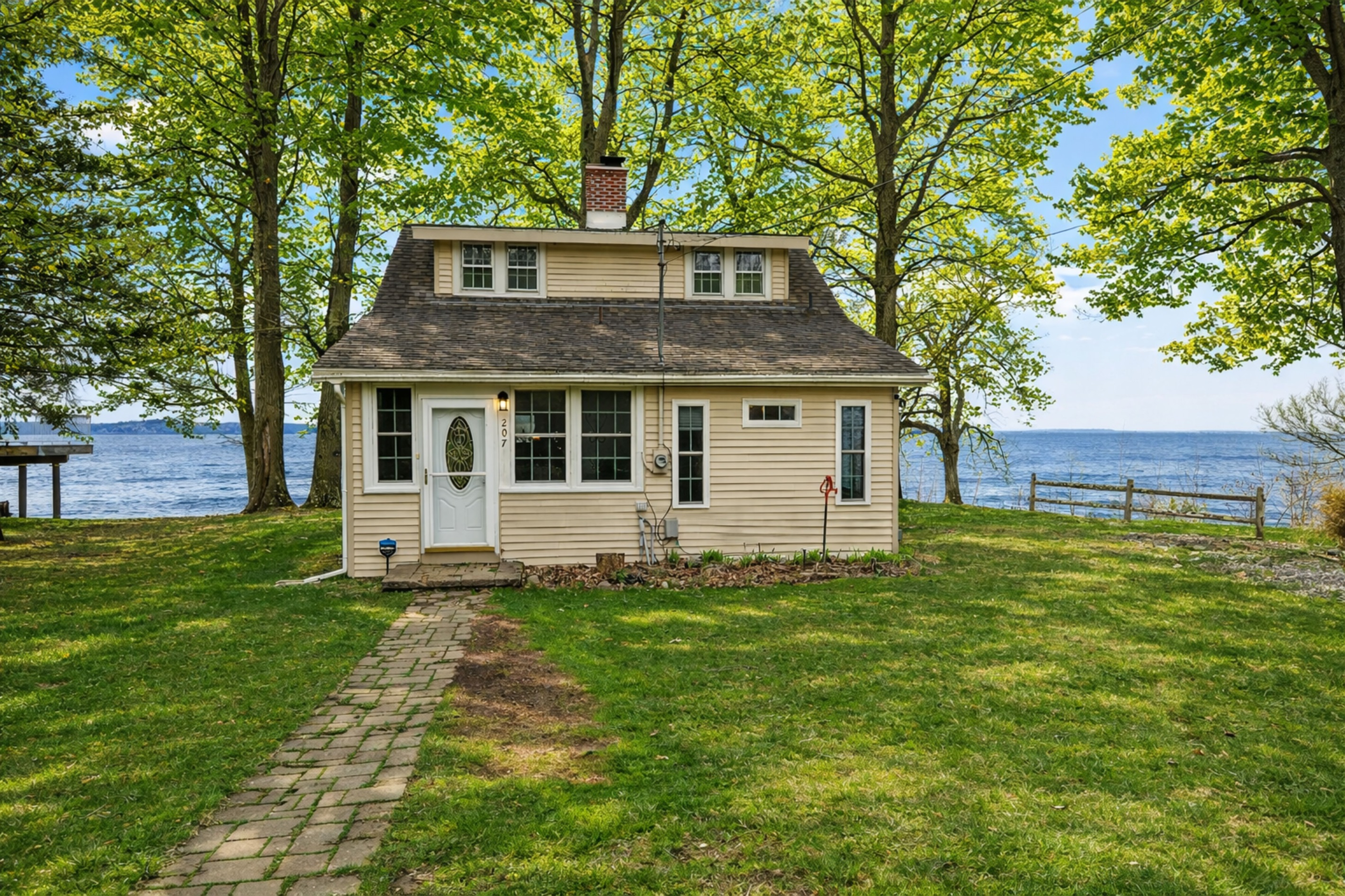 Enjoy a peaceful getaway with stunning lake views and a well-maintained front yard.