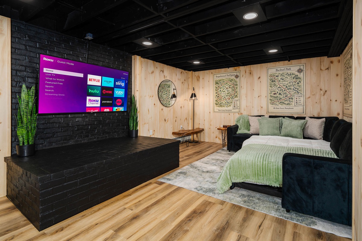 📺 A 65" TV and sectional that seats eight — the ultimate movie-and-game cave.