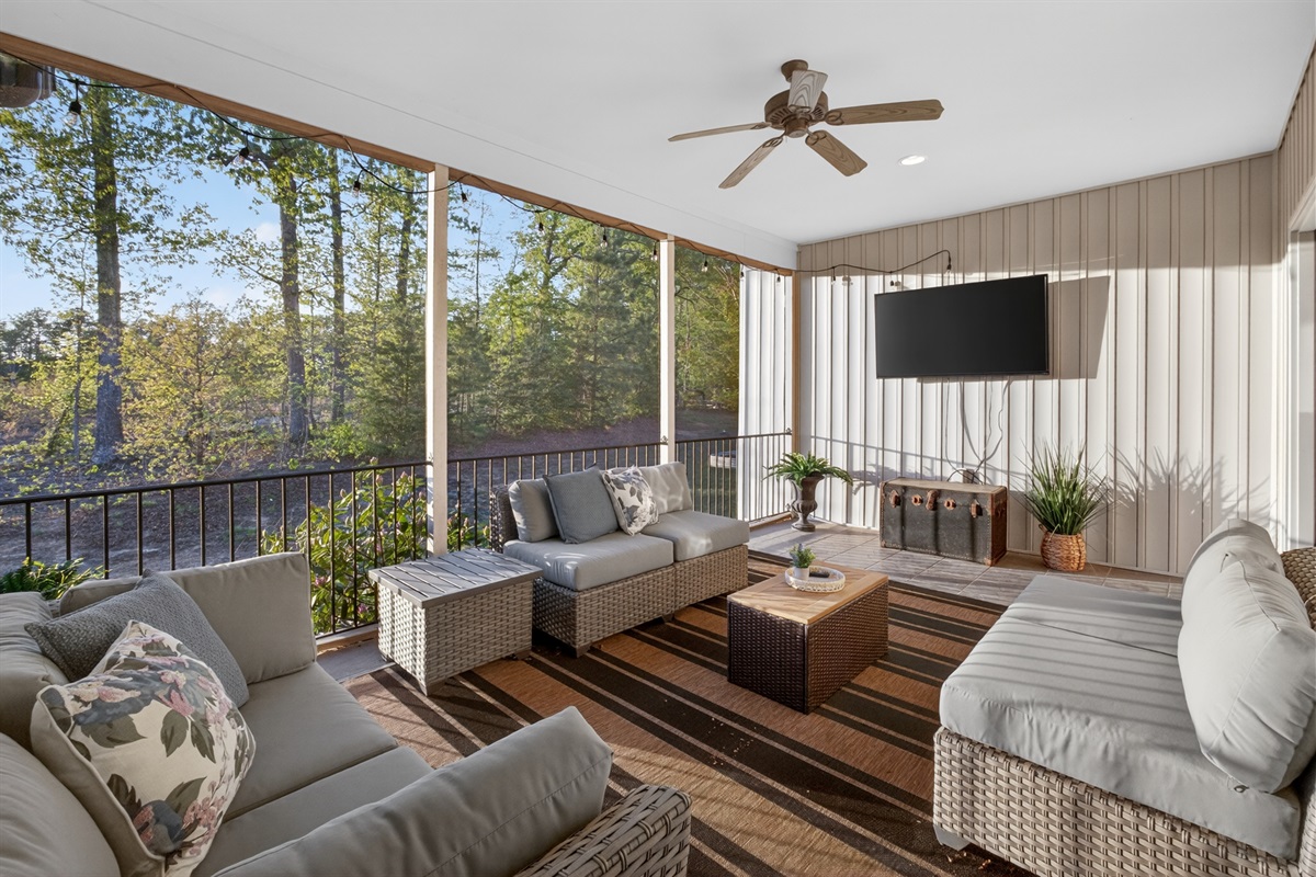 Screened porch at twilight with cozy seating and ambient lighting
