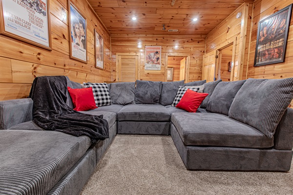 Cozy up in the theater room featuring a plush pit-style sofa perfect for movie marathons and game nights. Enjoy cinematic sound with the new Polk Audio sound bar.