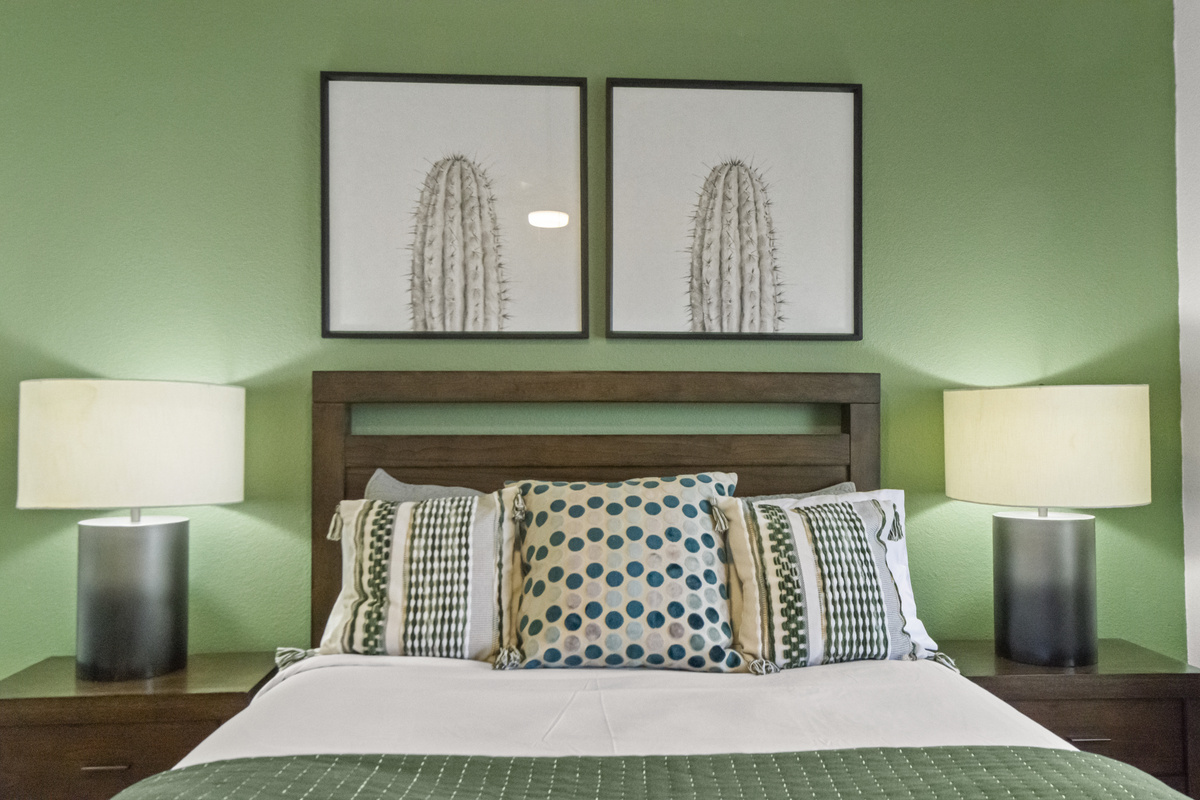 Cozy primary bedroom with a comfortable bed, fresh linens, decorative accents, and a peaceful atmosphere.