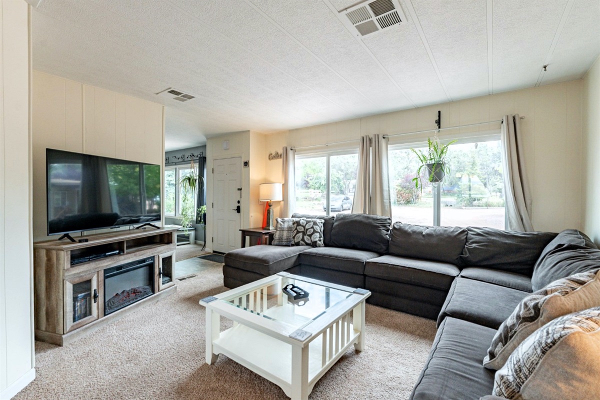 Bright, welcoming family room with comfy sectional and ample seating.