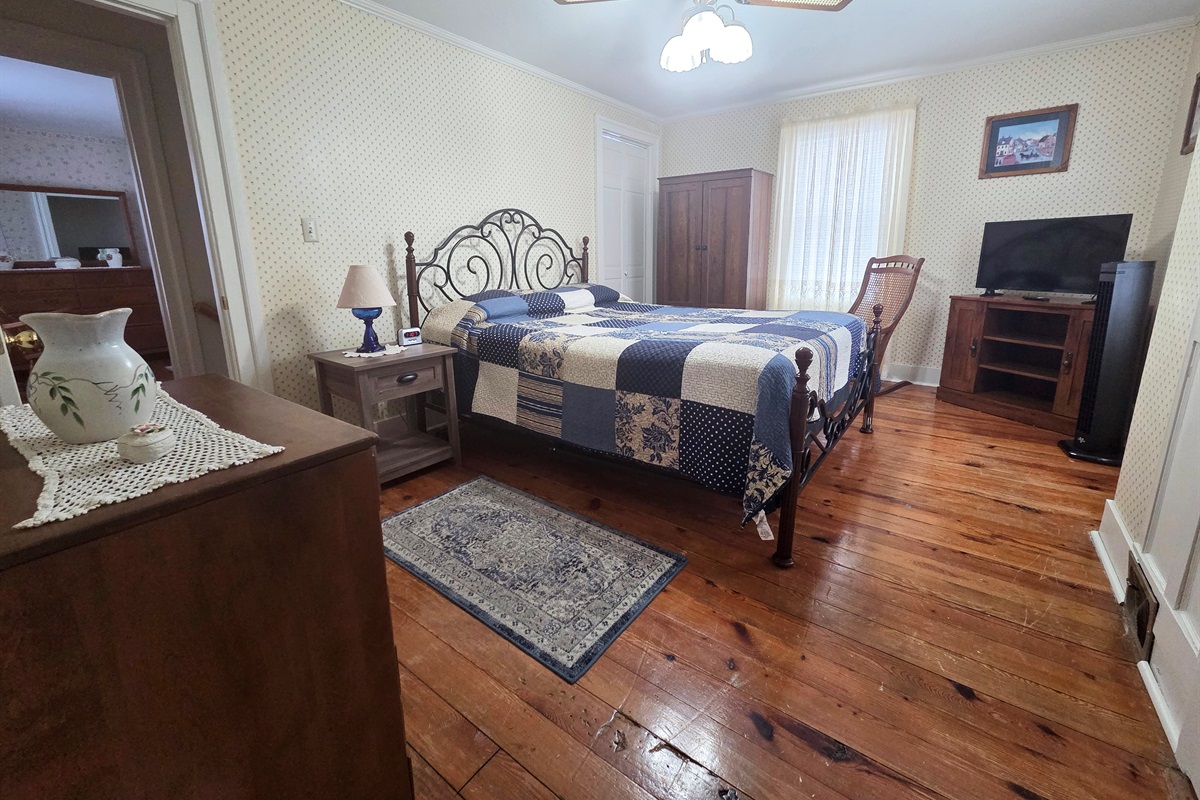 The Master bedroom upstairs features a comfortable queen bed.