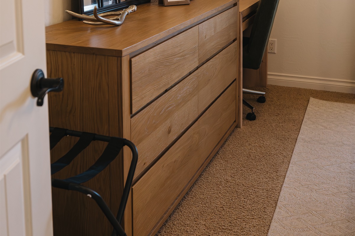 Quiet workspace with dresser storage, cozy desk chair, and warm cabin styling—perfect for remote work, journaling, or unwinding during your White Mountains getaway.
