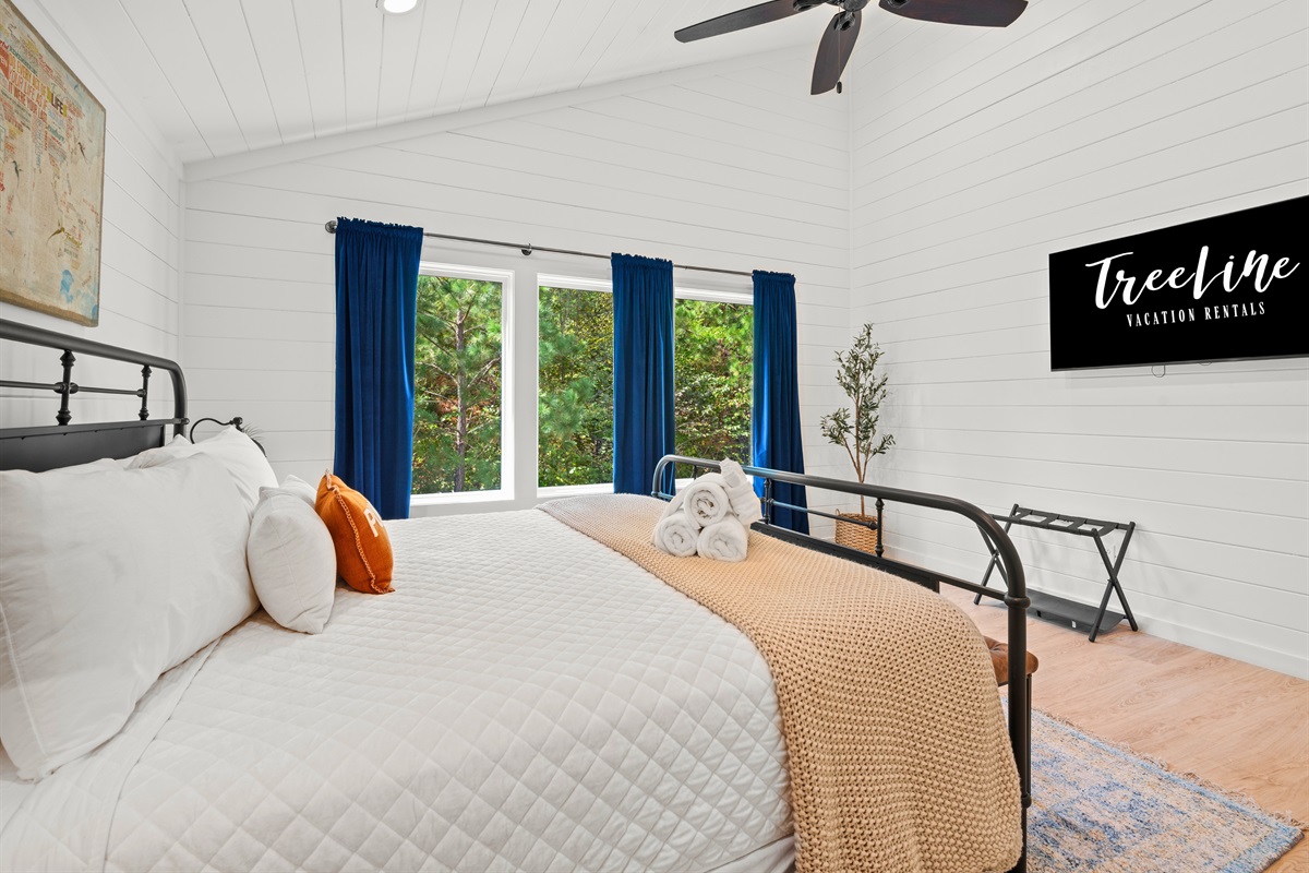 Second king bedroom with soft lighting and warm tones.