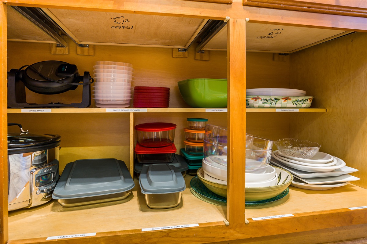 lots of serving dishes, platters, baking dishes and left over containers