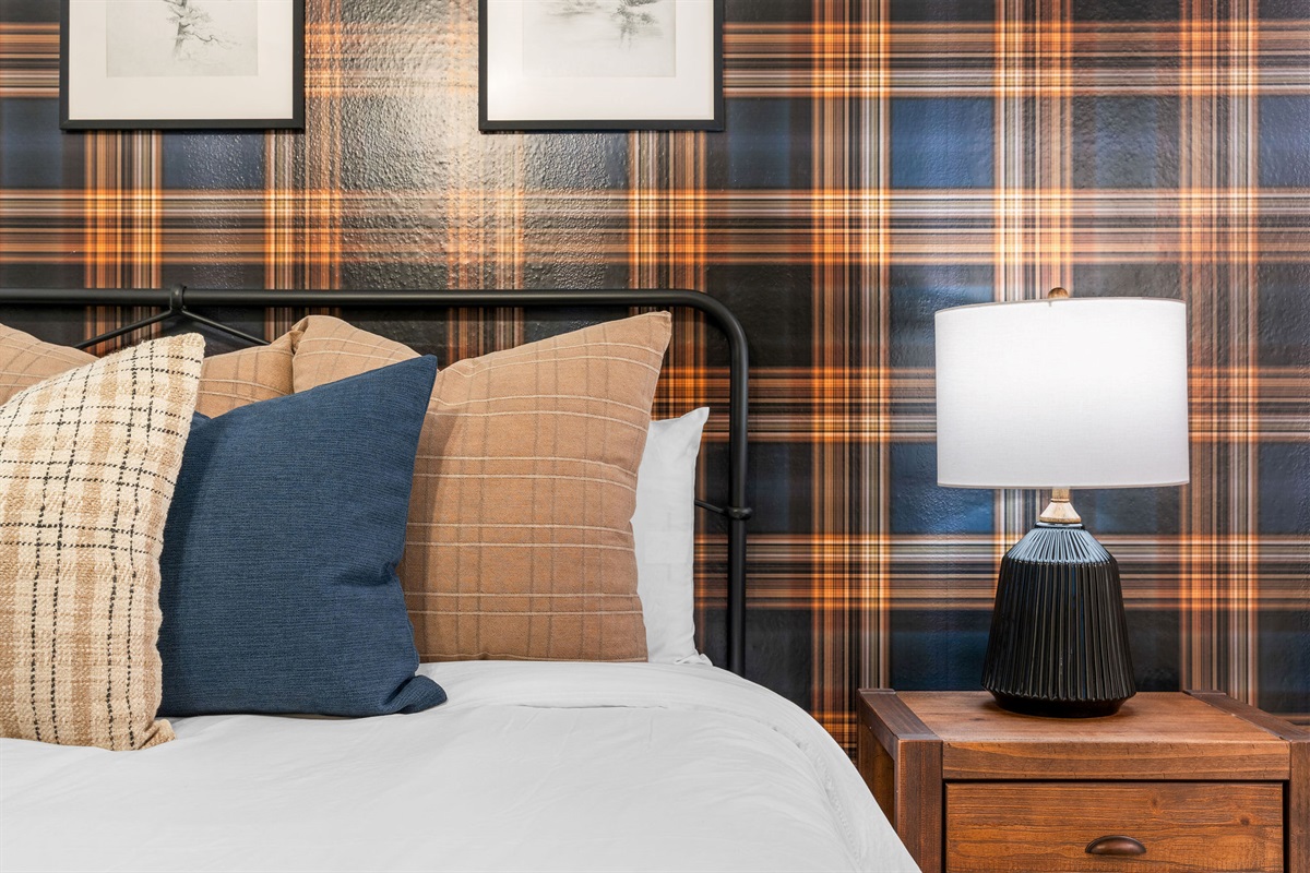 Inviting bedroom with comfy linens and charming decor details.