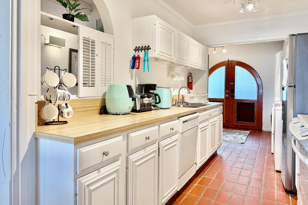 Kitchen with dishwasher, stove and microwave/convection oven combo.