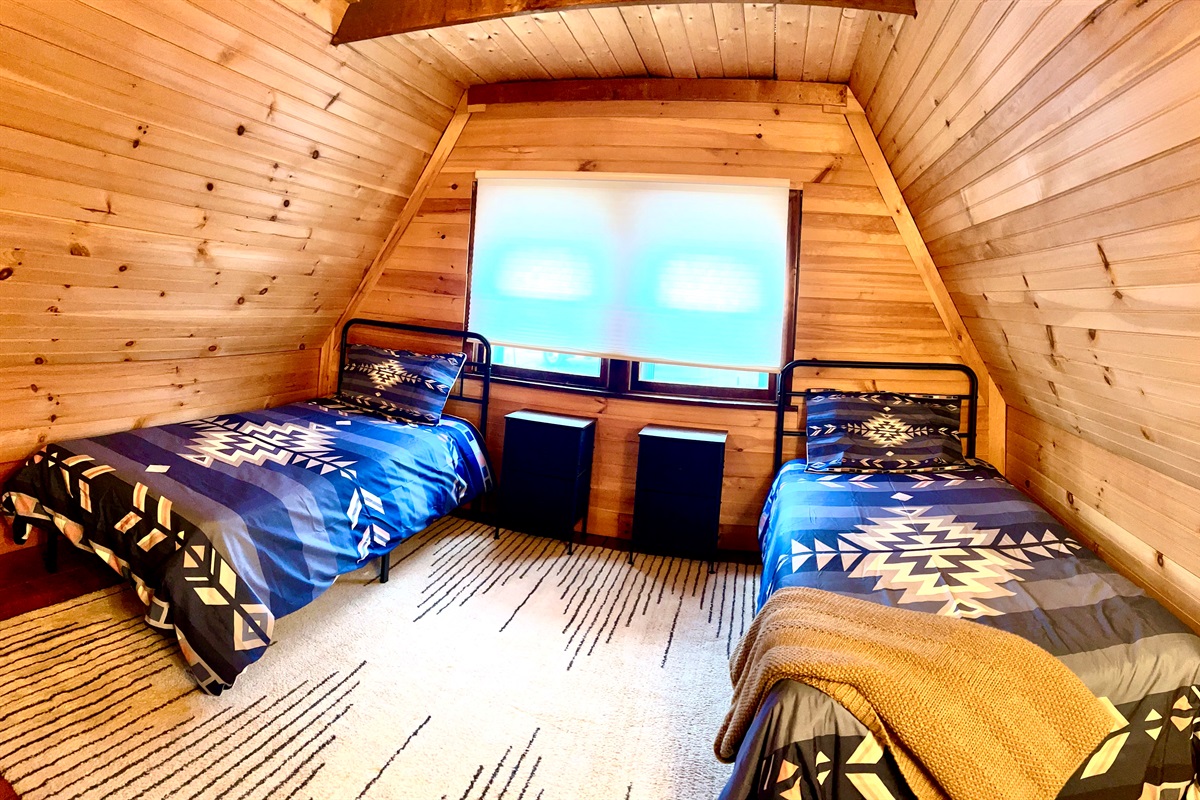 First loft bedroom with two twins, please note there is an open doorway separating the two loft bedrooms.