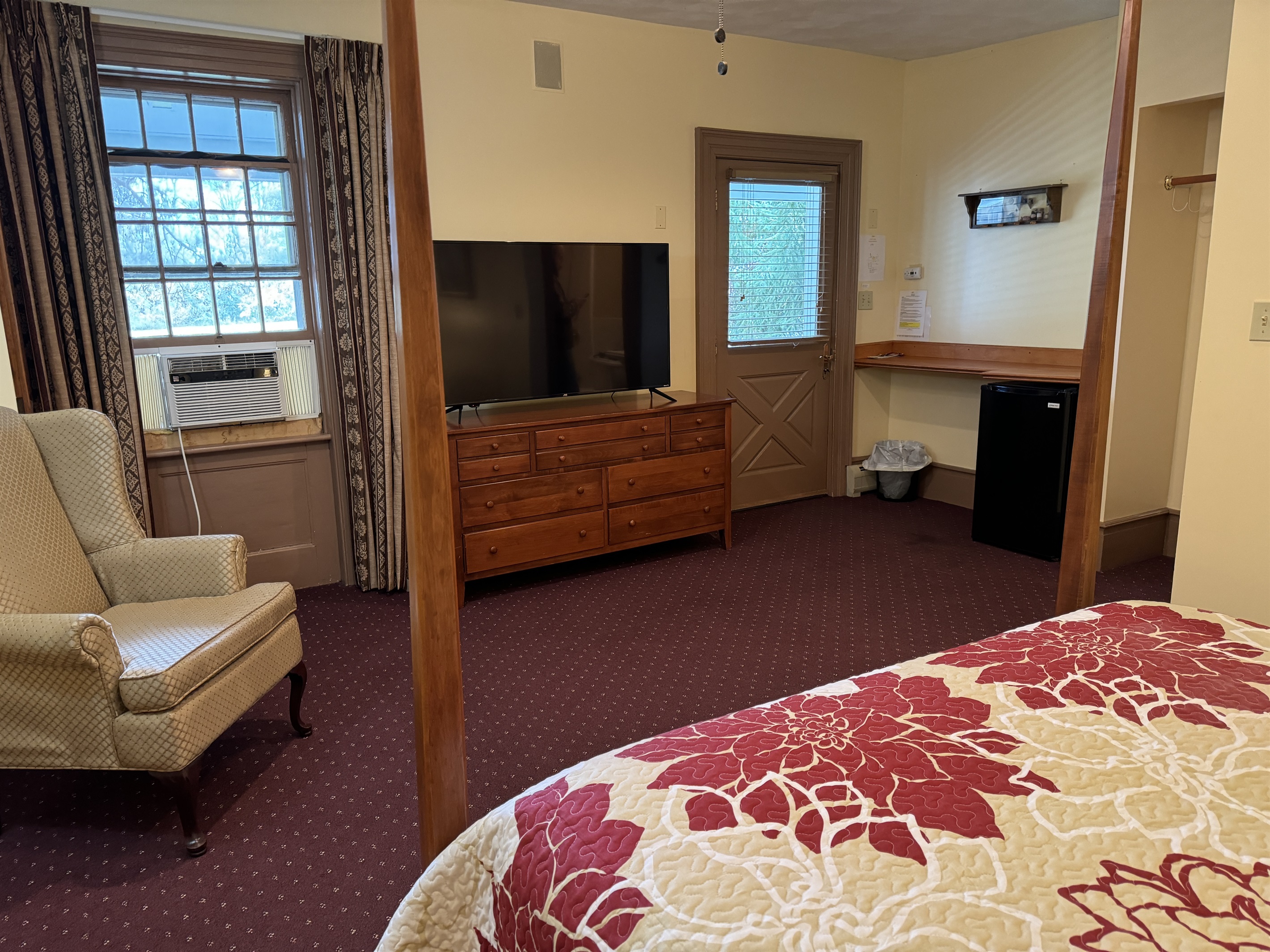 Guest room #1 with large Roku TV and mini fridge.