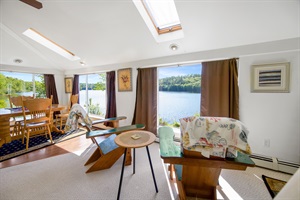 Dining room in the background with 1 coffee table and 2 armchairs