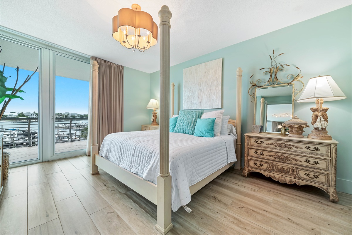 Wake up to stunning water views in this beautifully appointed primary bedroom. Seamlessly blending indoor and outdoor living, the expansive sliding doors open to a private balcony, creating a serene and luxurious retreat.