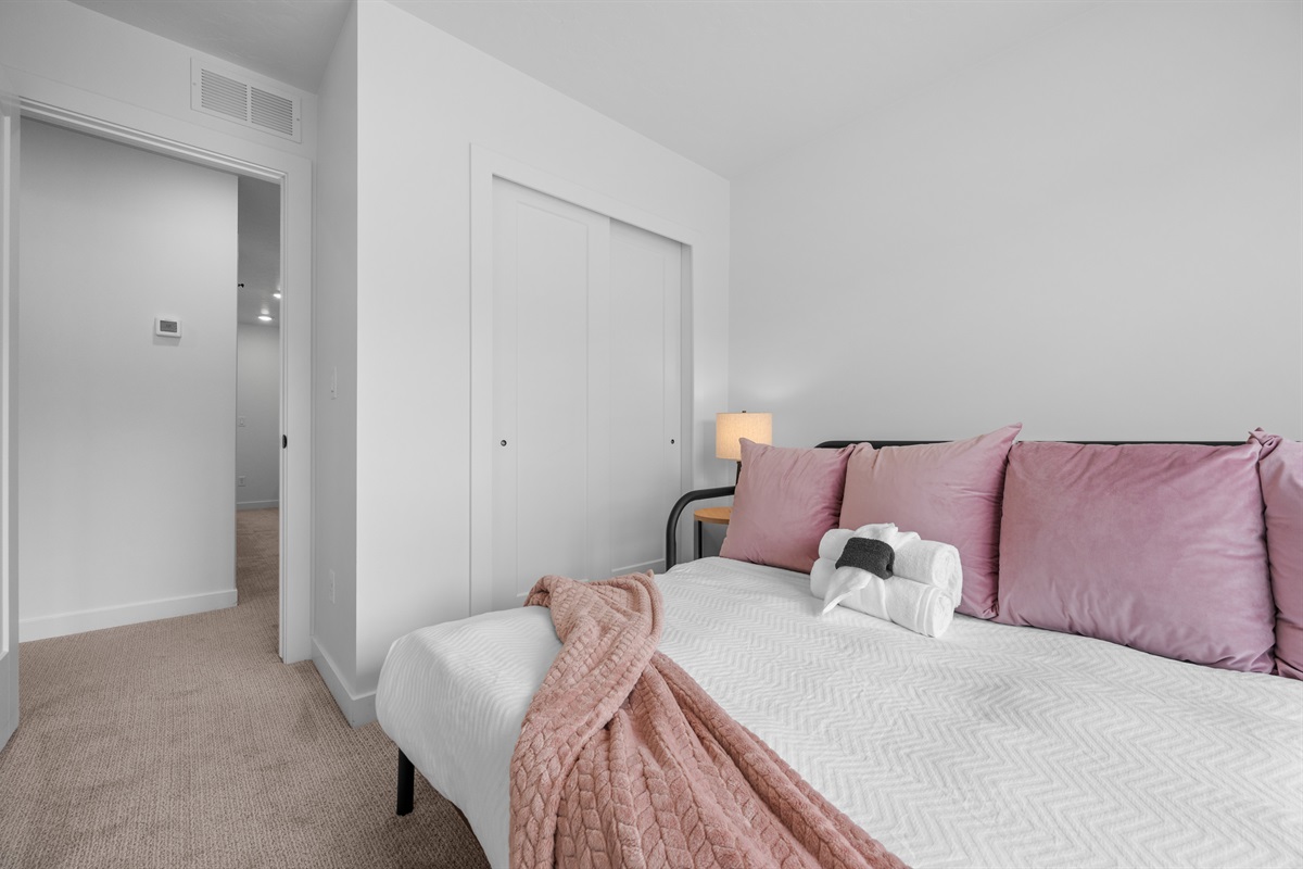 Comfortable bedroom with soft linens and ample storage.