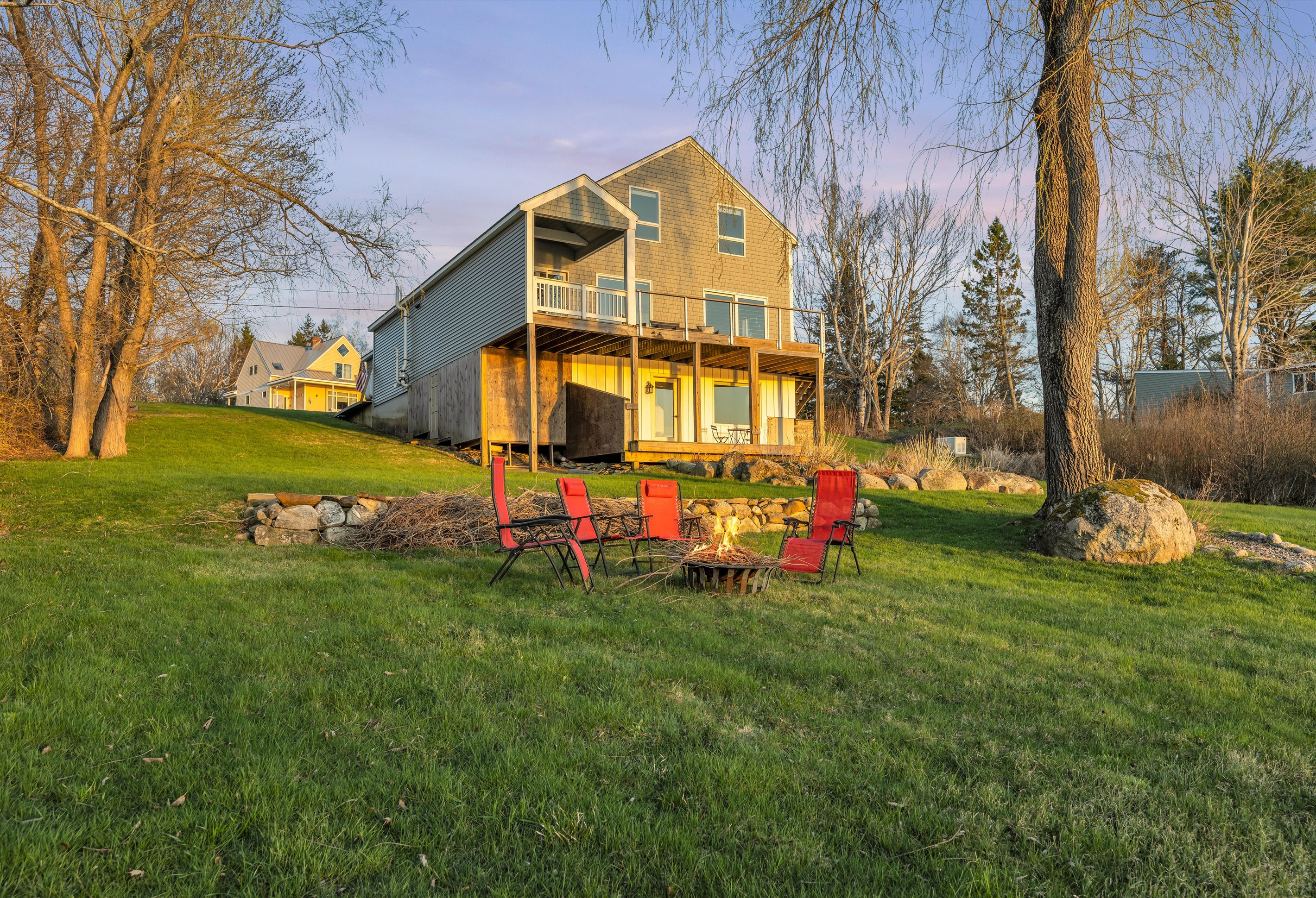 Backside of the house with chairs and tables with sunset light