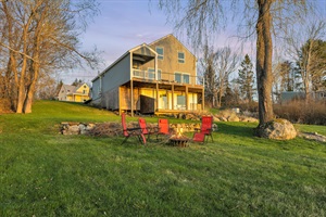 Backside of the house with chairs and tables with sunset light