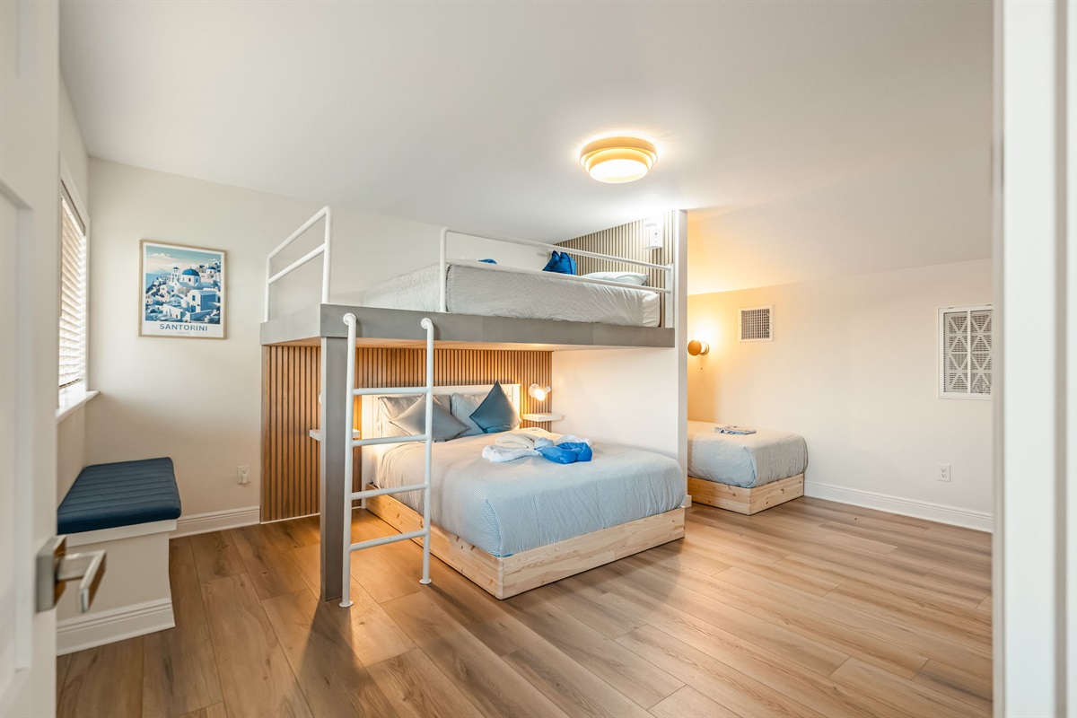 Spacious bunk bedroom featuring a queen bed below and twin bunk above — perfect for families and groups.