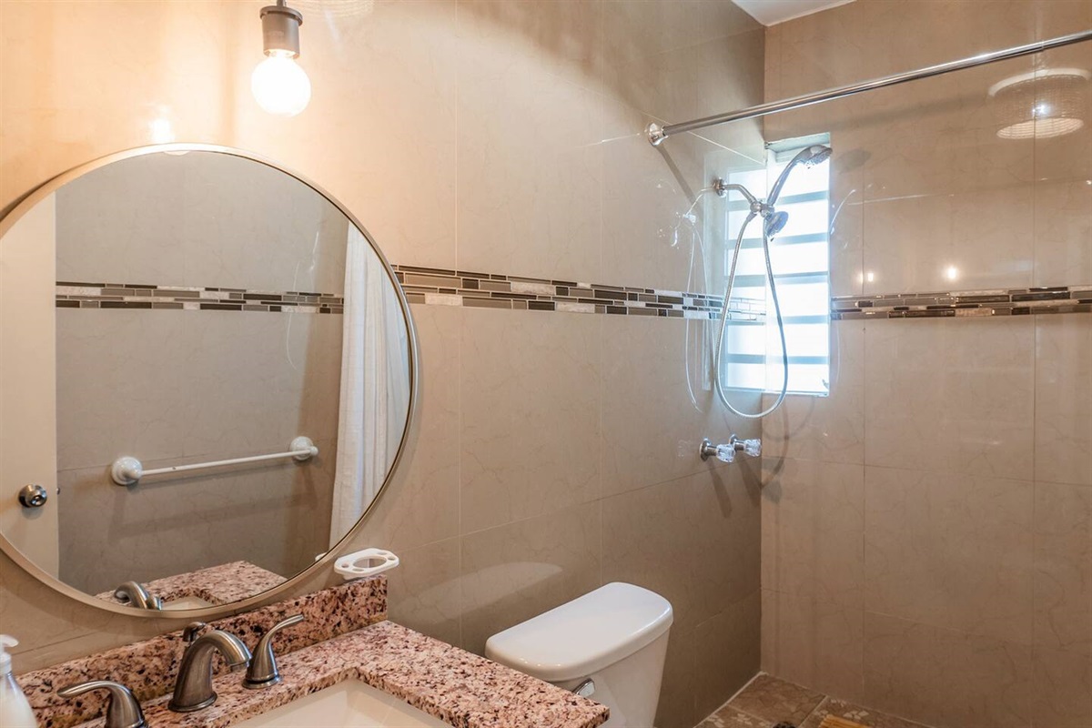 Modern bathroom with shower for convenience.