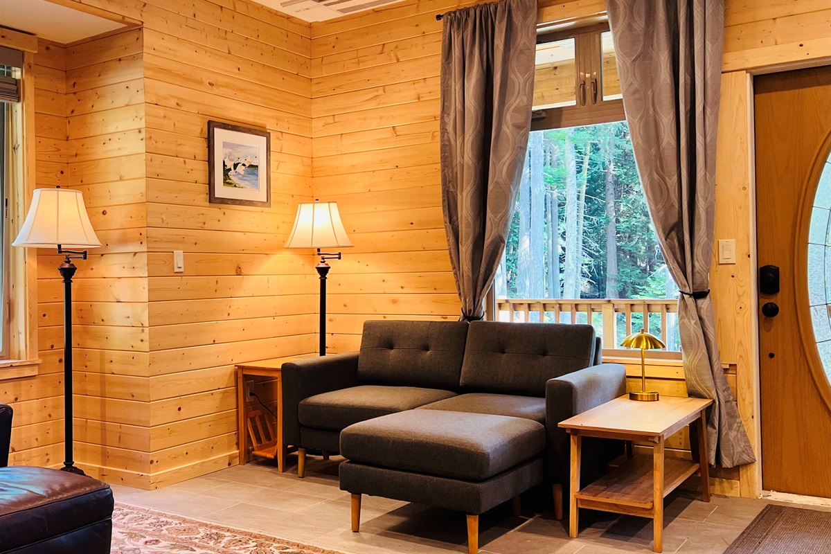 Inviting great room with large windows that bring in natural light and offer beautiful views.