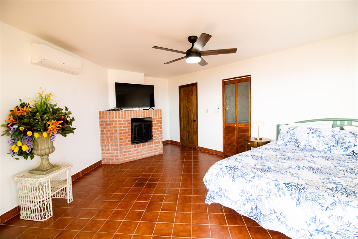 Principal Bedroom with King Bed, Fireplace, suite bathroom, and balcony.