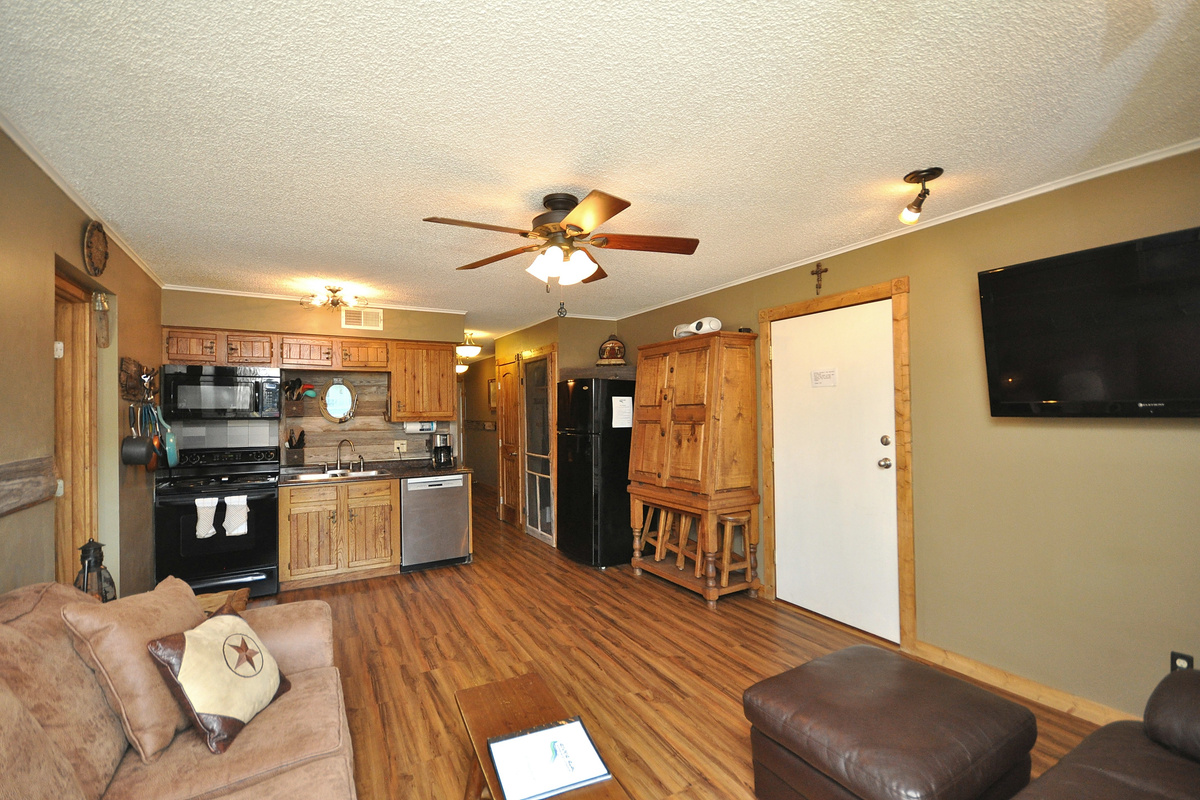 Kitchen opens to living and dining areas.