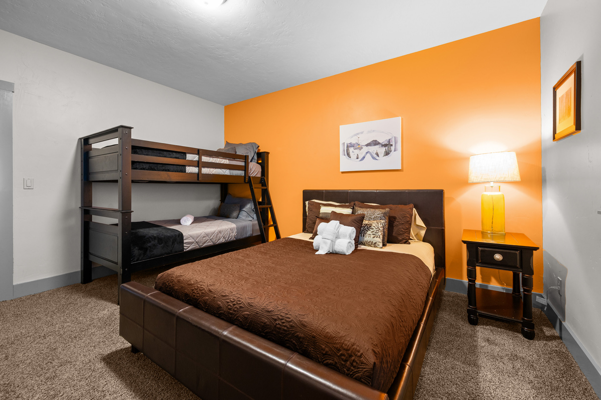 A Queen bed with Twin over Twin Bunk Beds