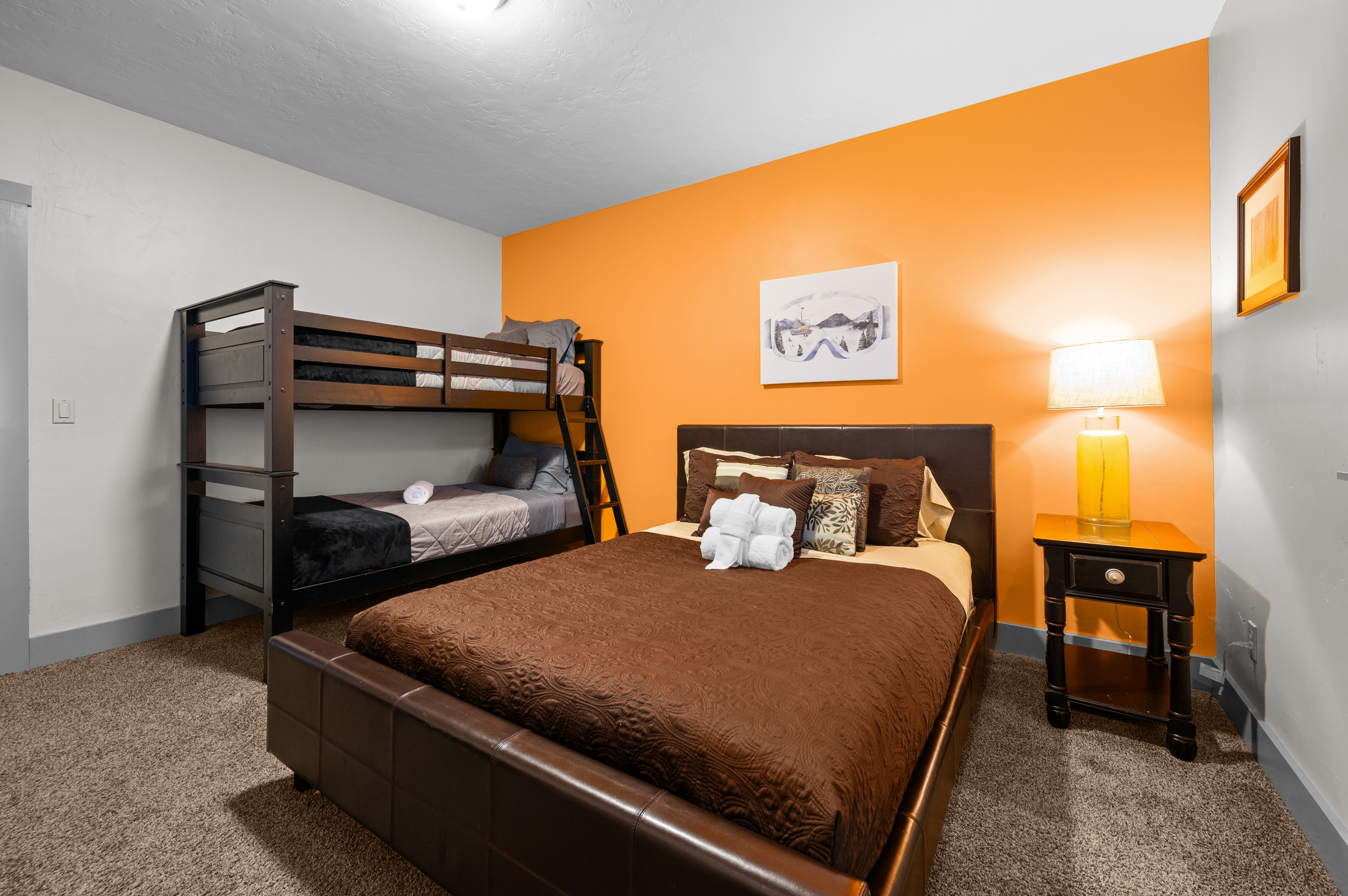 A Queen bed with Twin over Twin Bunk Beds