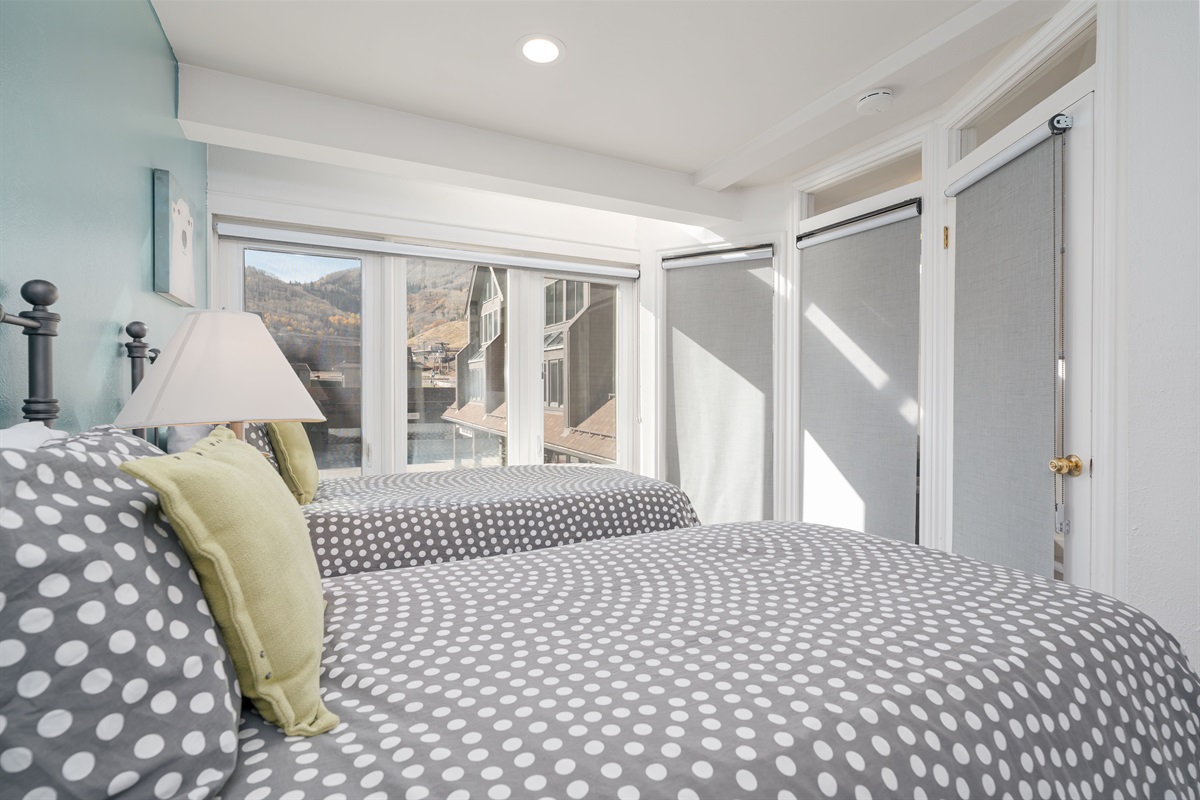 Bedroom 2. Twin beds overlooking the ice rink below. Separate walk in closet.