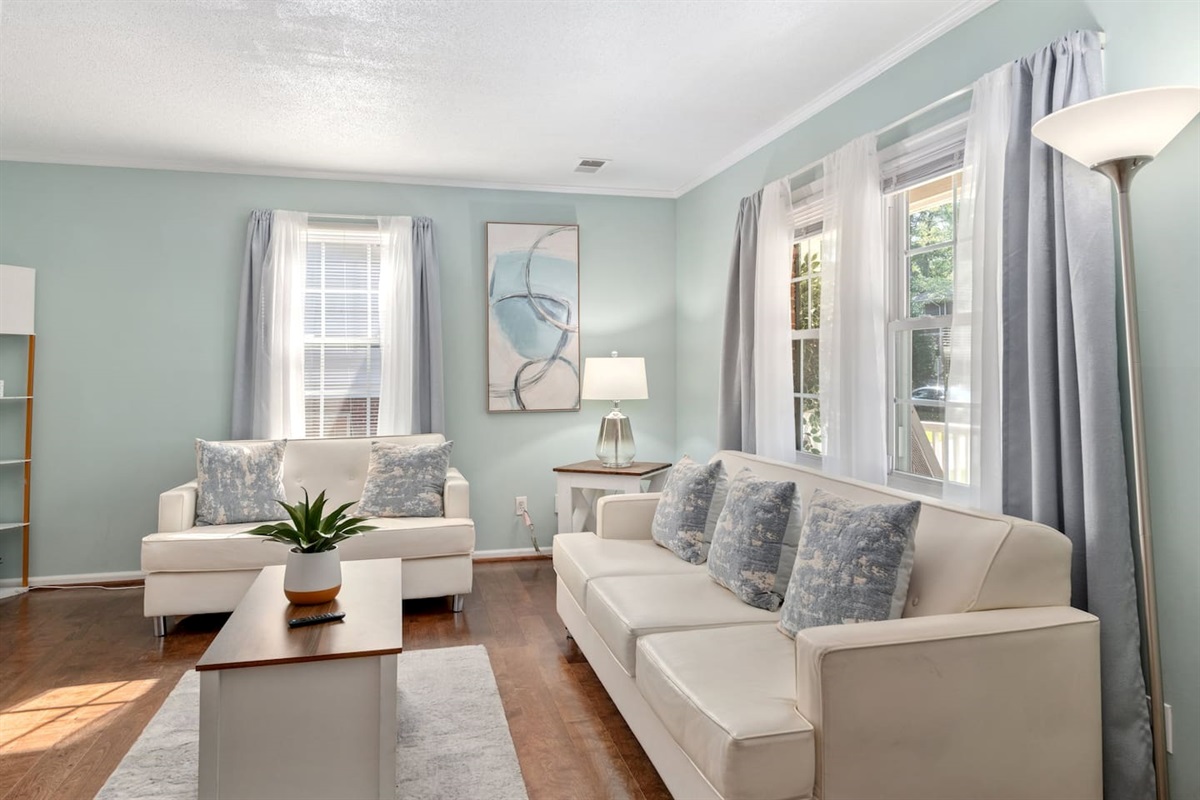 Light-filled living room with soft tones and plush seating — designed for family connection or quiet downtime. 