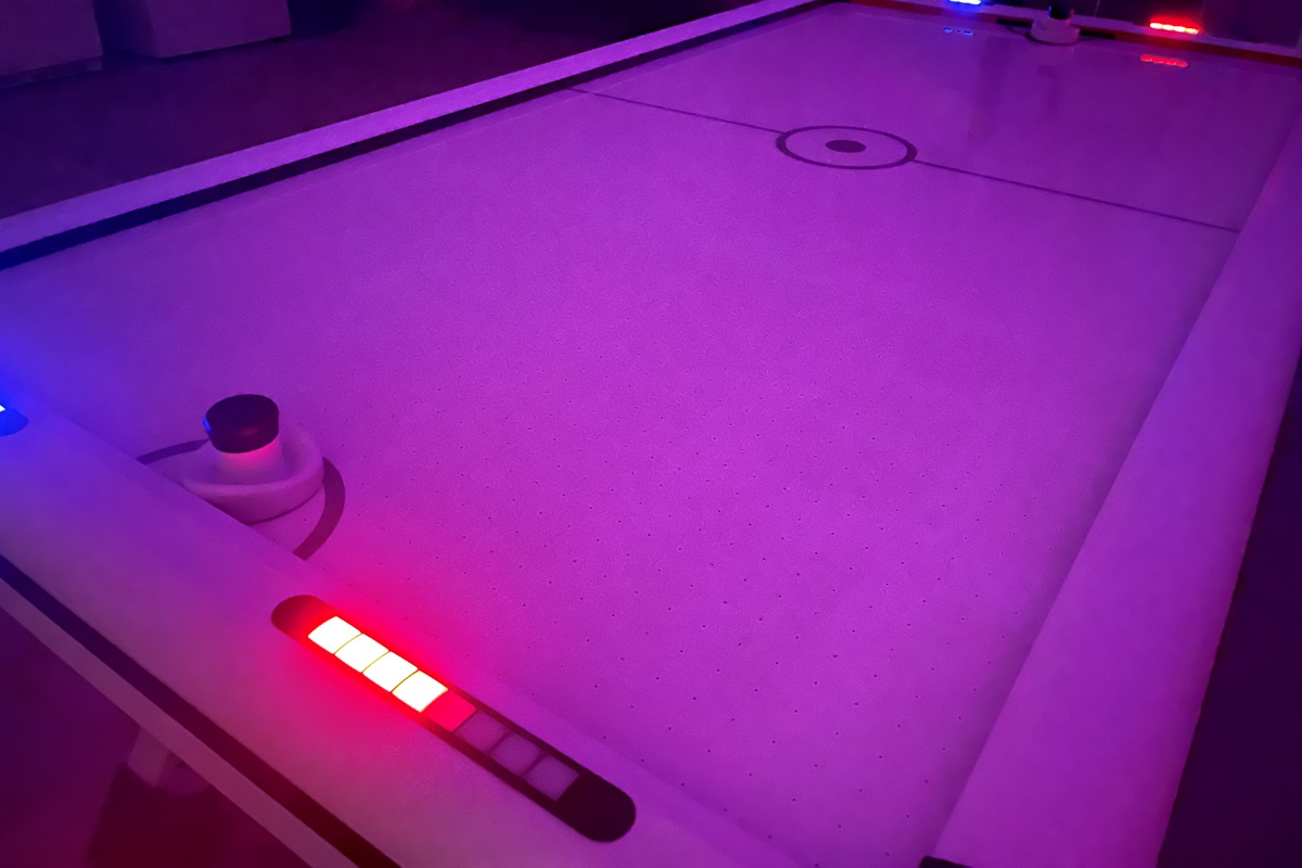 Enjoy a game of the LED air hockey table.