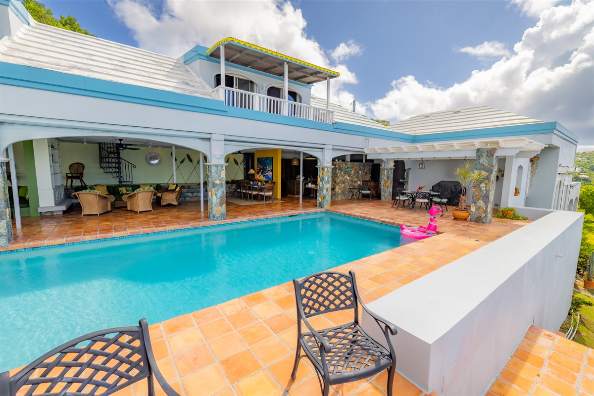 A spacious patio with large pool leads right into the open plan of this property