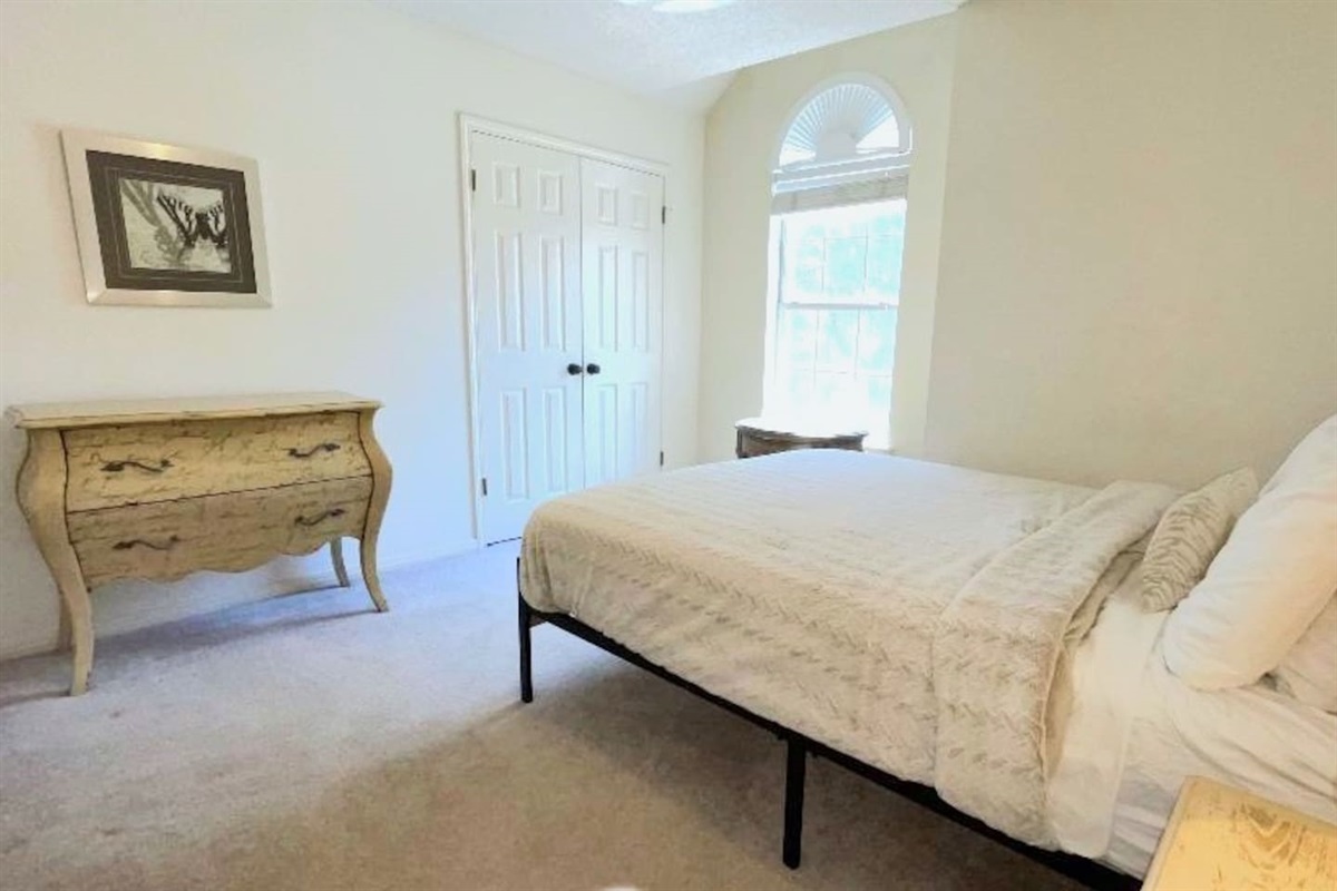 One of five bedrooms.  This one features queen sleeping, memory foam topper, bedside charging, nightstand and lighting.  Generous clothing storage in the closet and chest of drawers.