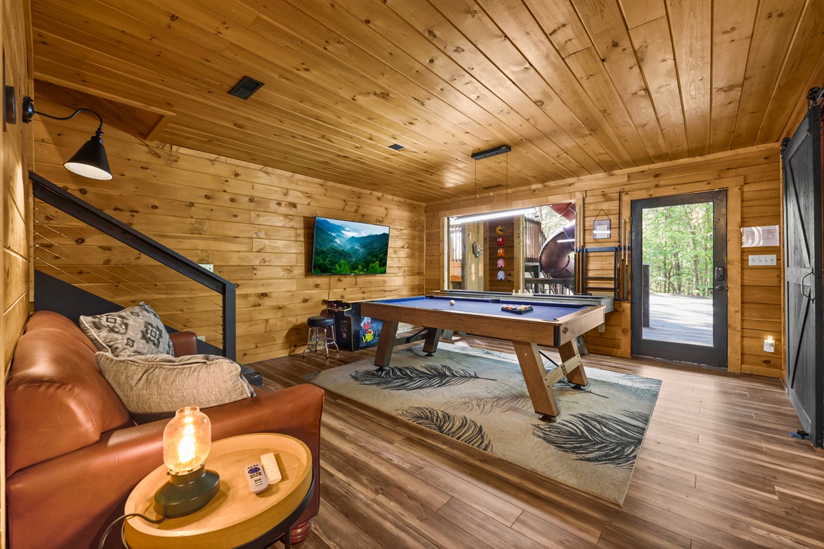 The game room has a sleeper sofa to offer  flexible sleeping arrangements