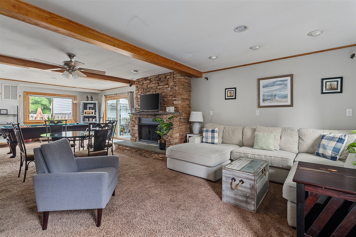 Living Room: Bright and airy space with a lovely stone fireplace and stylish decor awaits your arrival!