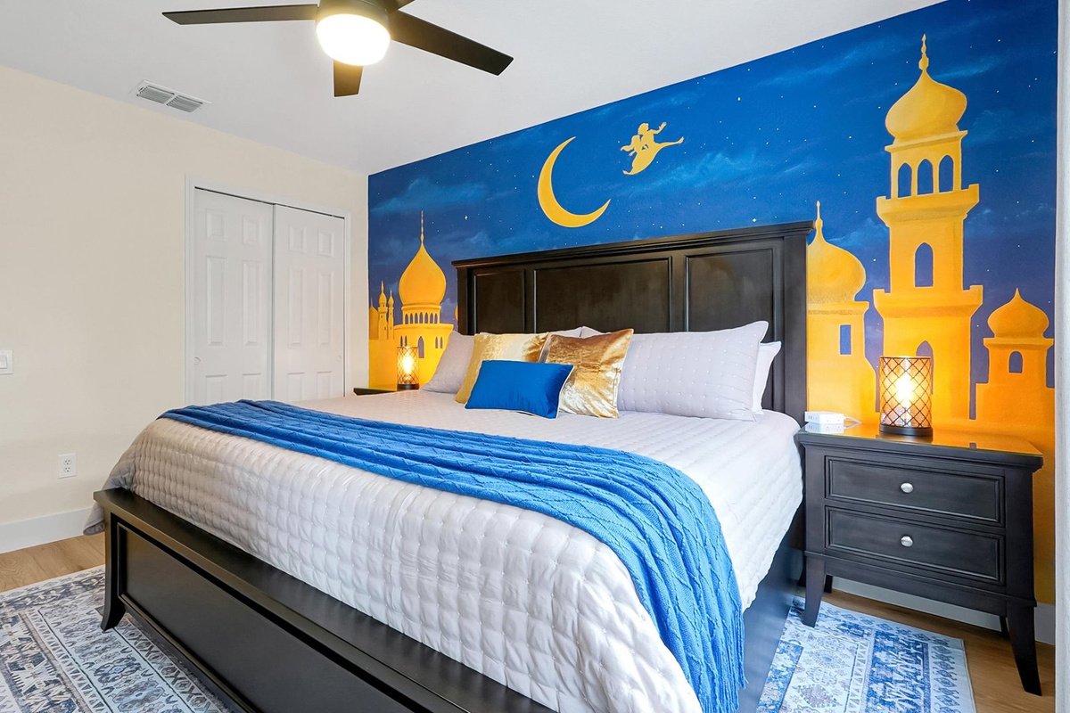 Aladdin King Suite: King bedroom with a hand-painted Agrabah palace mural, TV and ample storage.