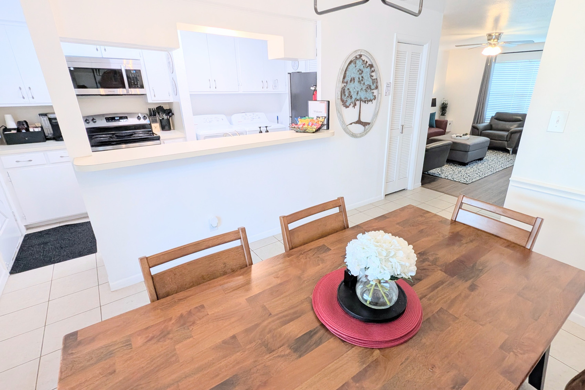 The downstairs living space is designed for gathering, with easy access to both the kitchen and living room.