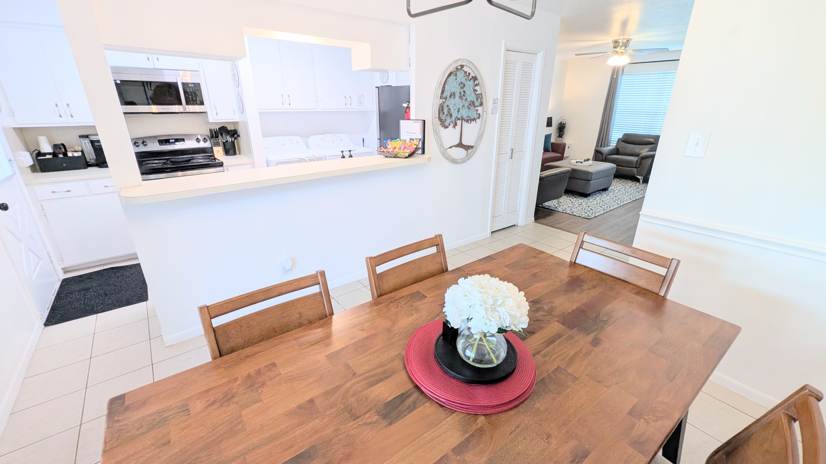 The downstairs living space is designed for gathering, with easy access to both the kitchen and living room.