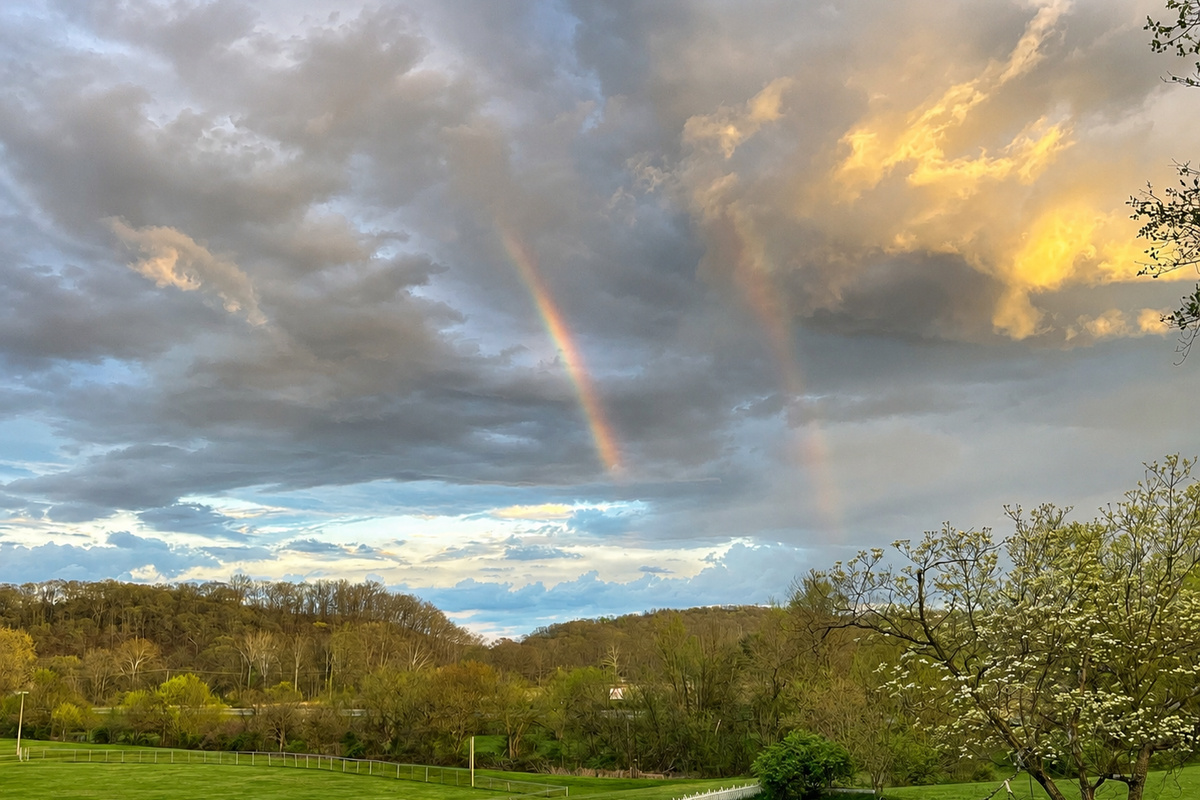 Double rainbow out the front porch overlooking the hill