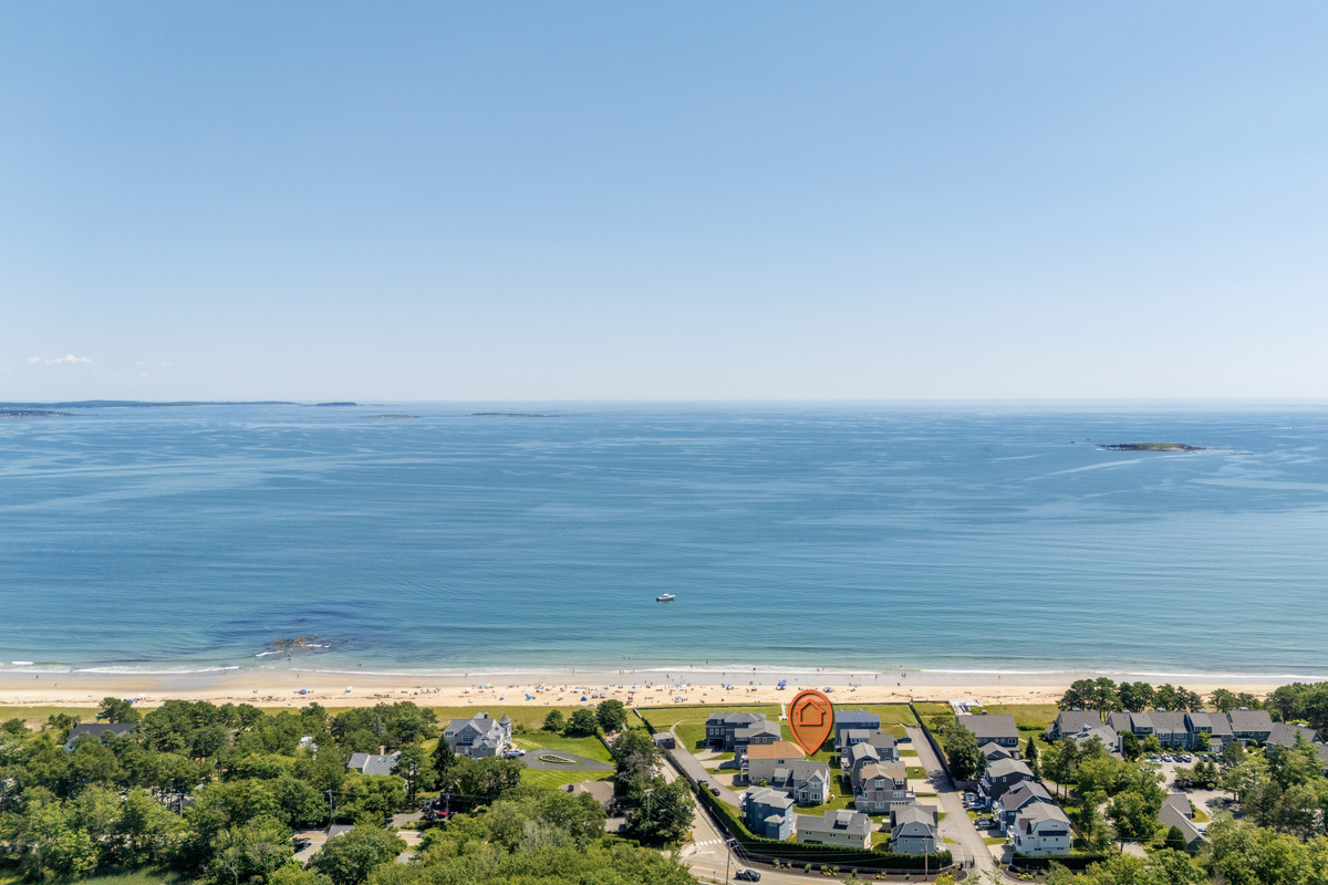 An aerial perspective shows just how close the neighborhood is to the beach and beautiful blue water.