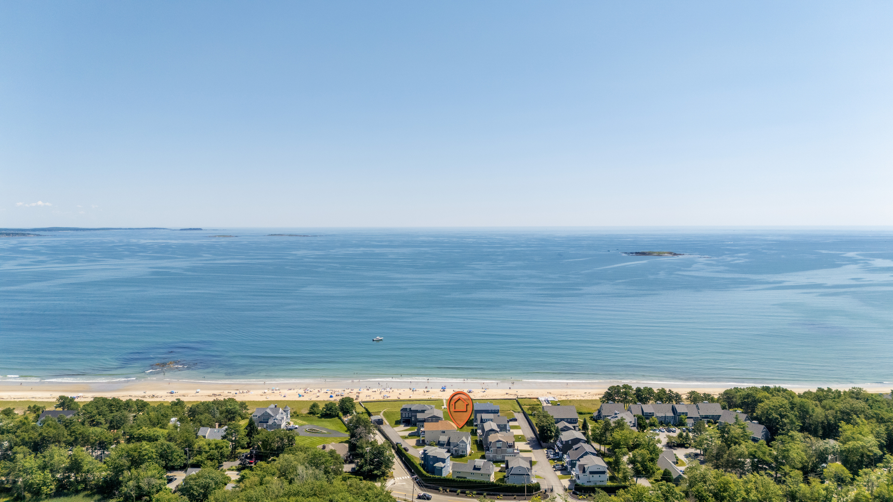 An aerial perspective shows just how close the neighborhood is to the beach and beautiful blue water.