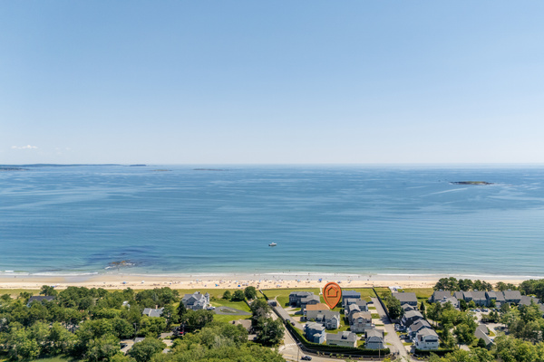 An aerial perspective shows just how close the neighborhood is to the beach and beautiful blue water.