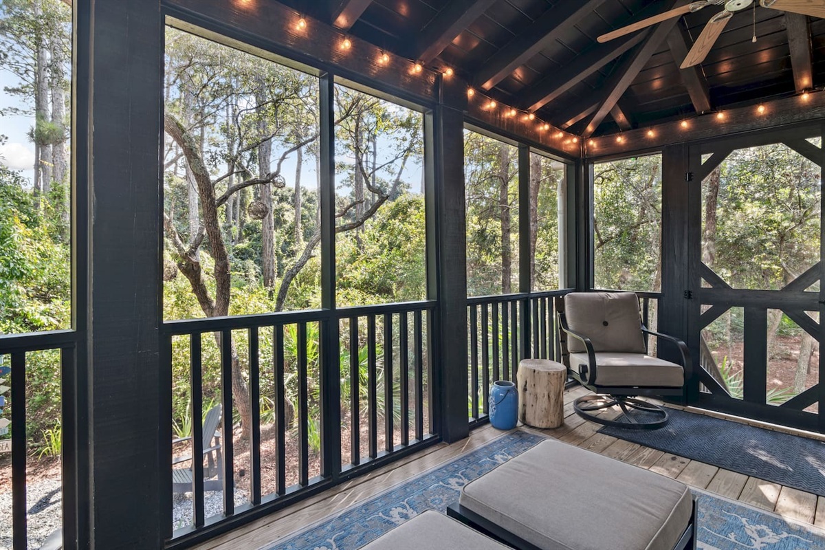 Screened Porch
A guest favorite, the screened-in porch features a cozy bed swing, sofa, rocker, and footstools. Two ceiling fans and string lights create the perfect setting for morning coffee, family time, or evening wine with peaceful wooded views.