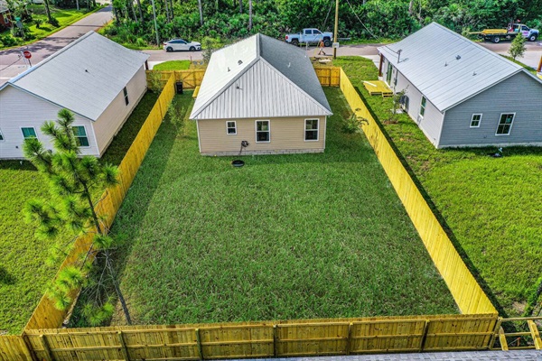 Aerial view of the fully fenced back yard - your pets will enjoy being able to roam the backyard.  The fence is a privacy fence.