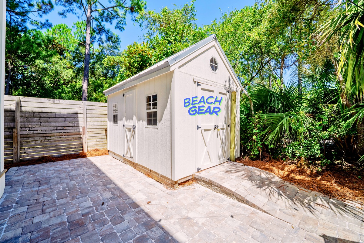 Shed stocked with beach gear—backpack chairs, wagon, and bikes ready for your adventure!