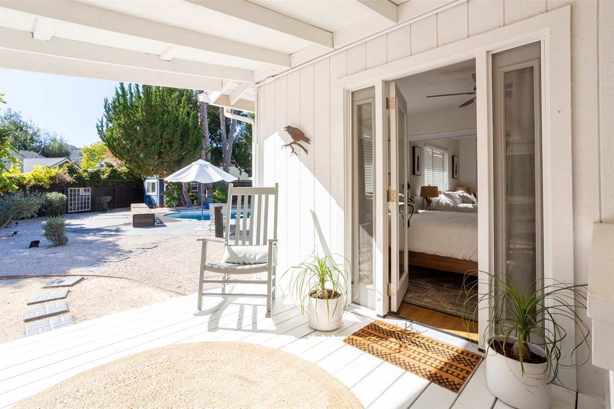 Step out of the queen bedroom onto a relaxing porch to enjoy your coffee or wine while relaxing in the rocking chair.