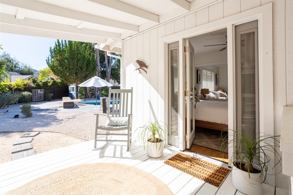 Step out of the queen bedroom onto a relaxing porch to enjoy your coffee or wine while relaxing in the rocking chair.